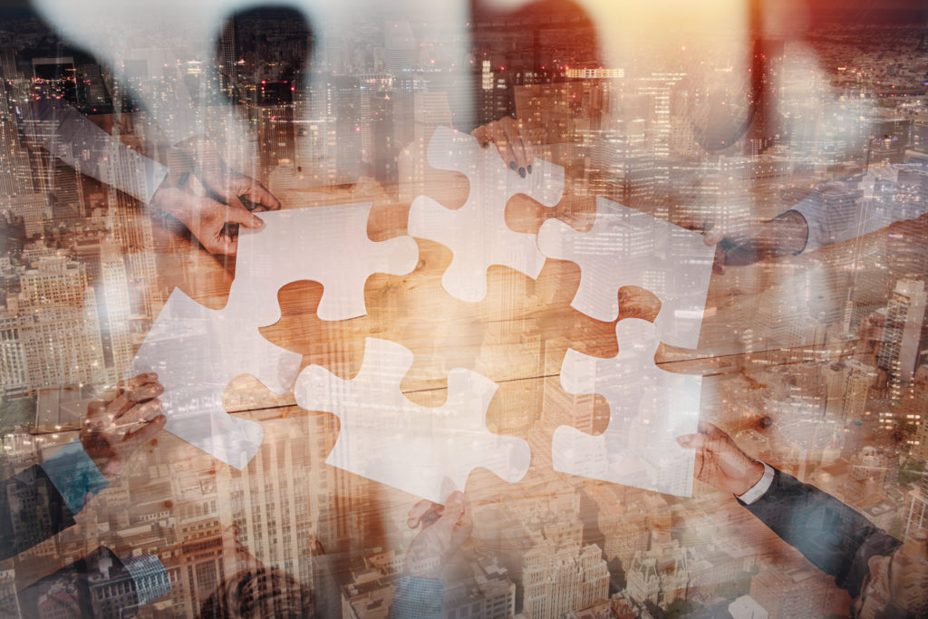 Business people connect puzzle pieces as integration and startup